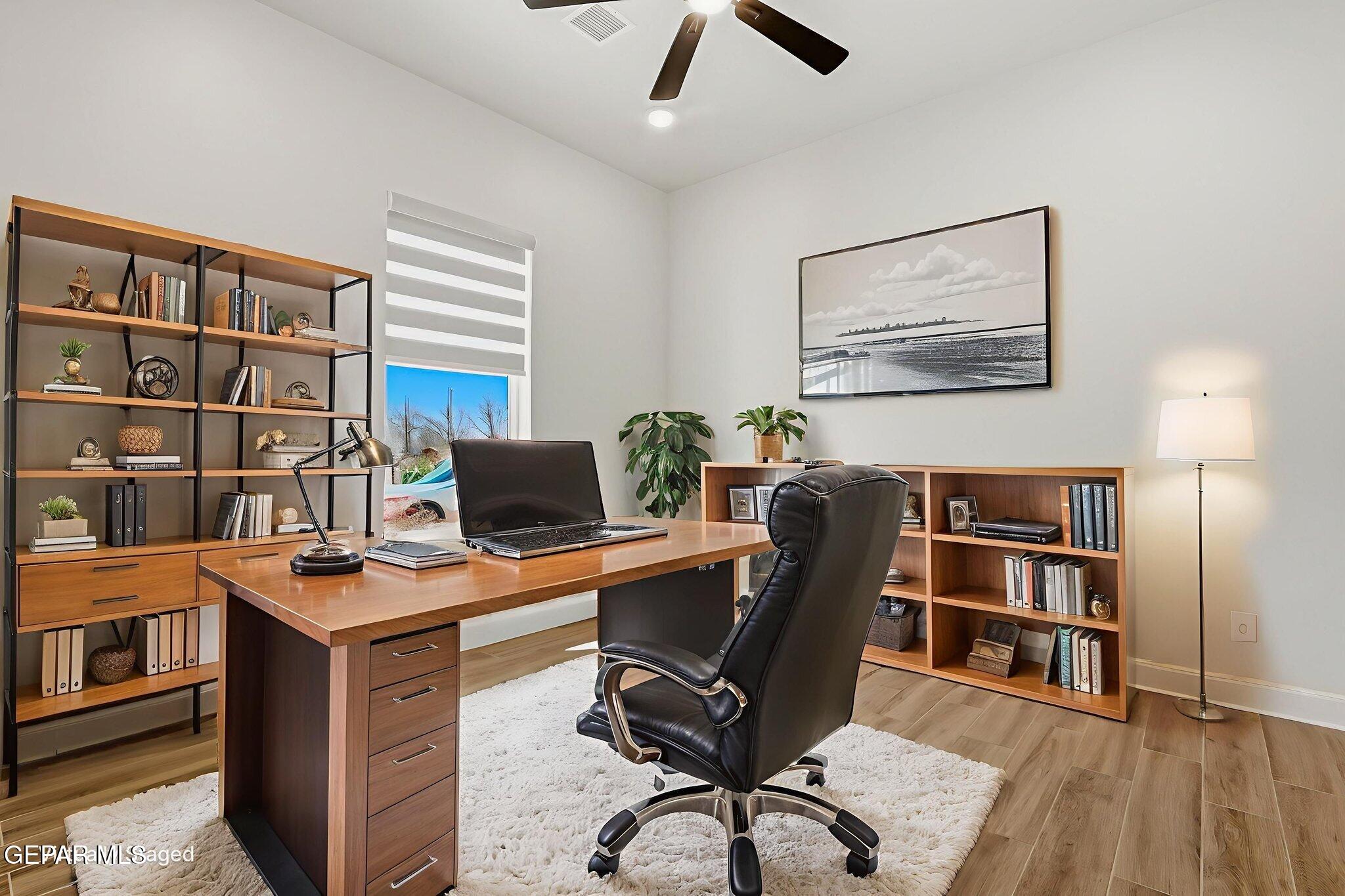 12329 Sugden Road Clint, TX 79836 - Photo 24 of 101 a view of a workspace with furniture and a bookshelf