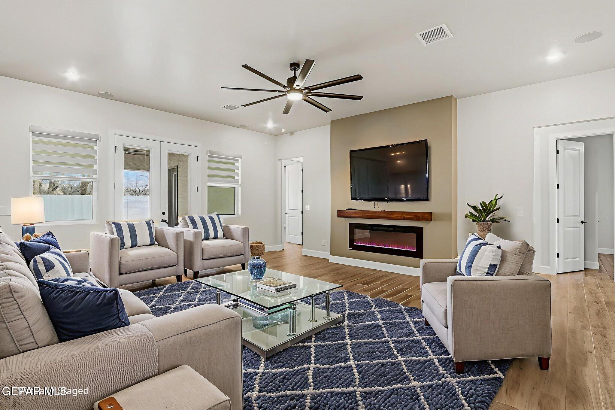 12329 Sugden Road Clint, TX 79836 - Photo 27 of 101 a living room with furniture a flat screen tv and a fireplace
