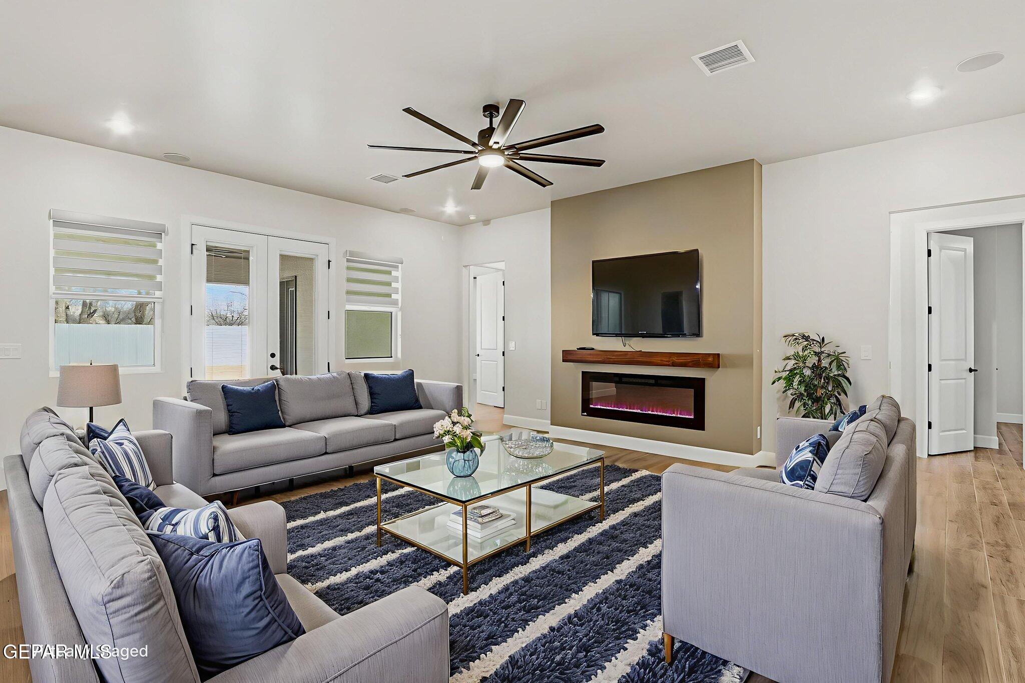12329 Sugden Road Clint, TX 79836 - Photo 30 of 101 a living room with furniture a fireplace and a flat screen tv