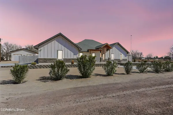 a view of white house with a snow on the road