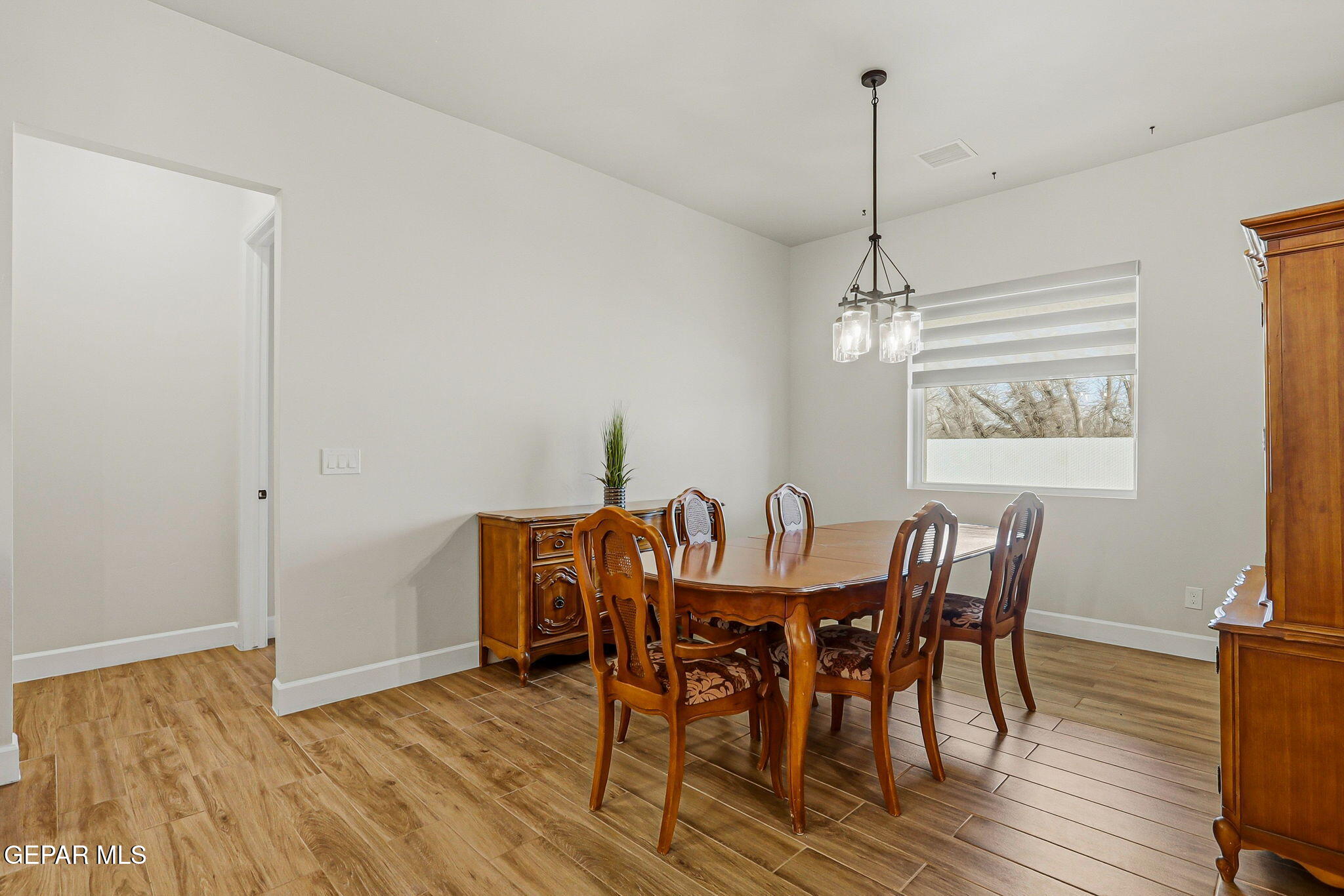 12329 Sugden Road Clint, TX 79836 - Photo 42 of 101 a view of a dining room with furniture window and wooden floor