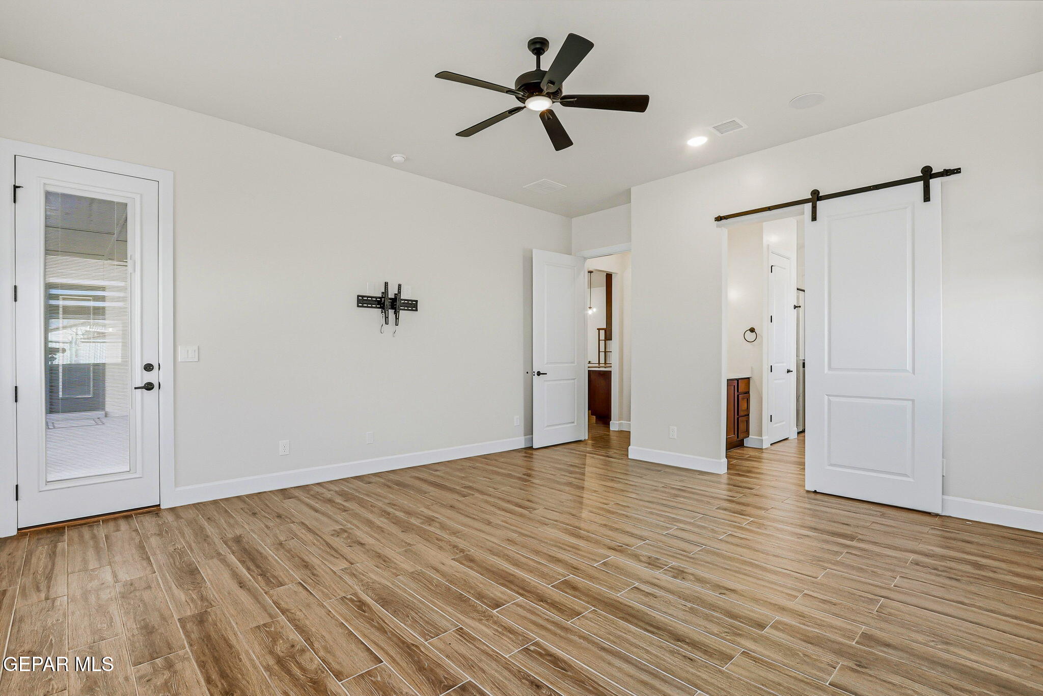 12329 Sugden Road Clint, TX 79836 - Photo 48 of 101 a view of empty room with wooden floor and ceiling fan