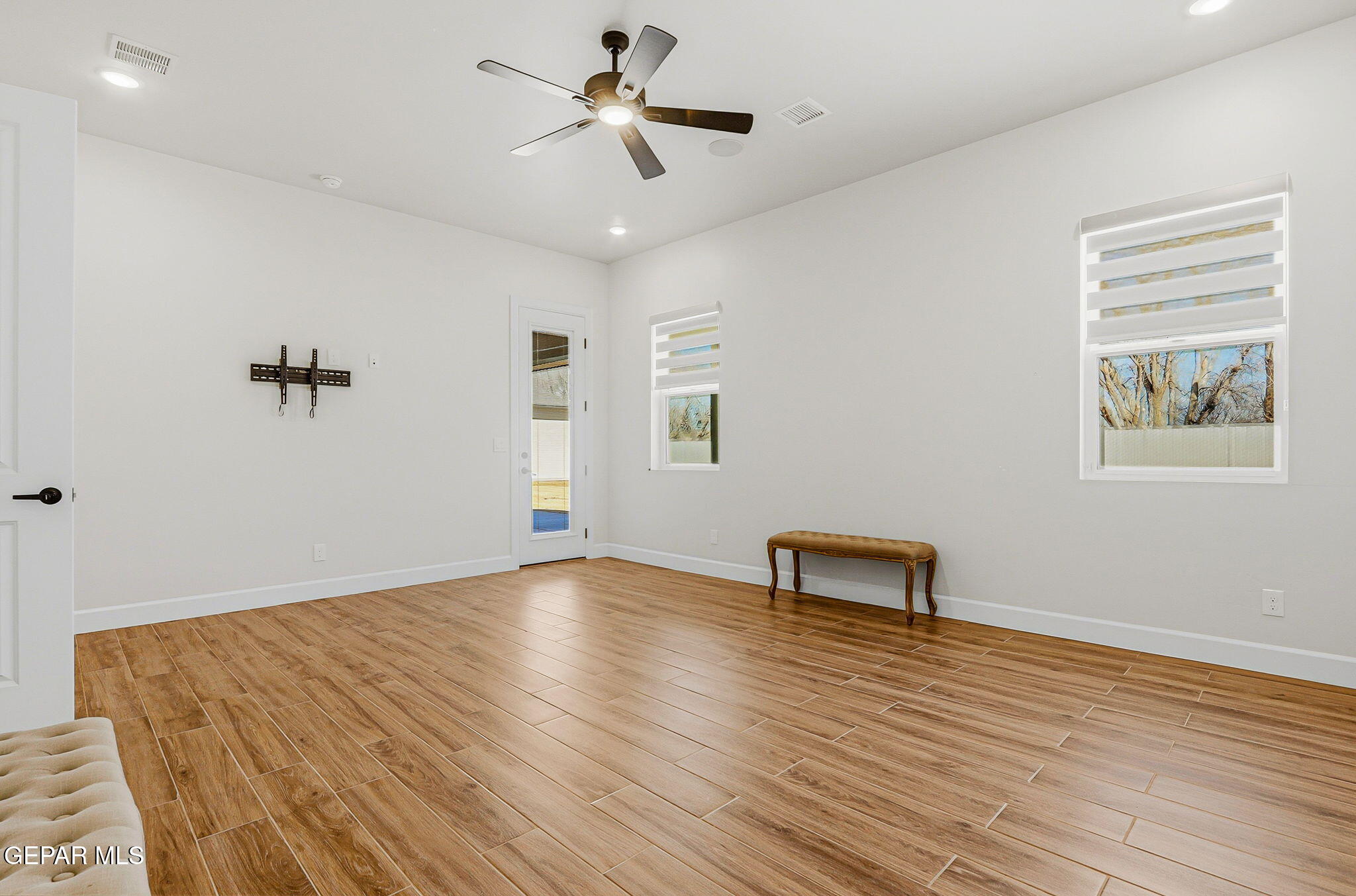 12329 Sugden Road Clint, TX 79836 - Photo 61 of 101 a view of workspace with wooden floor and a ceiling fan