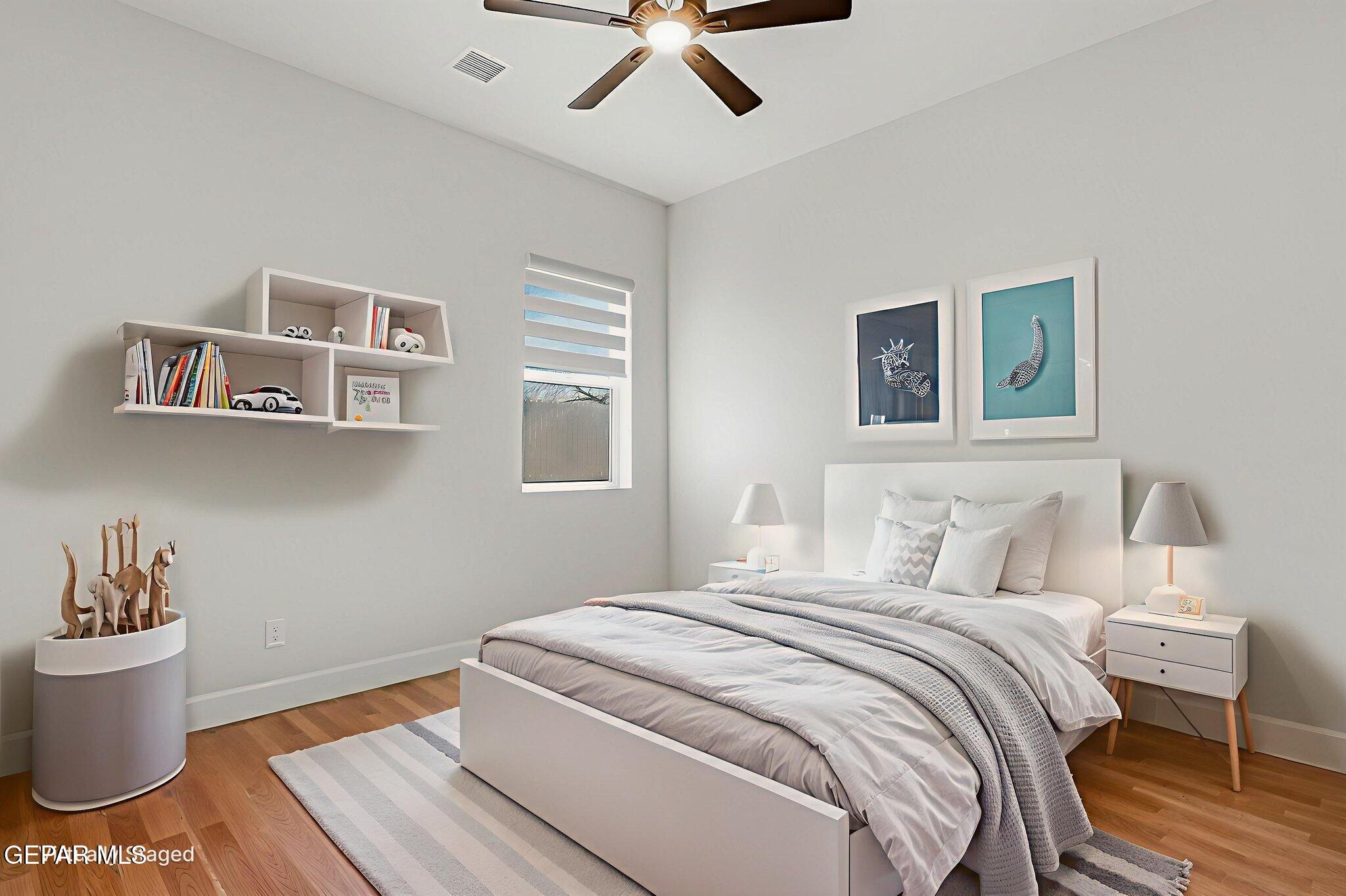 12329 Sugden Road Clint, TX 79836 - Photo 68 of 101 a bedroom with a bed and wooden floor