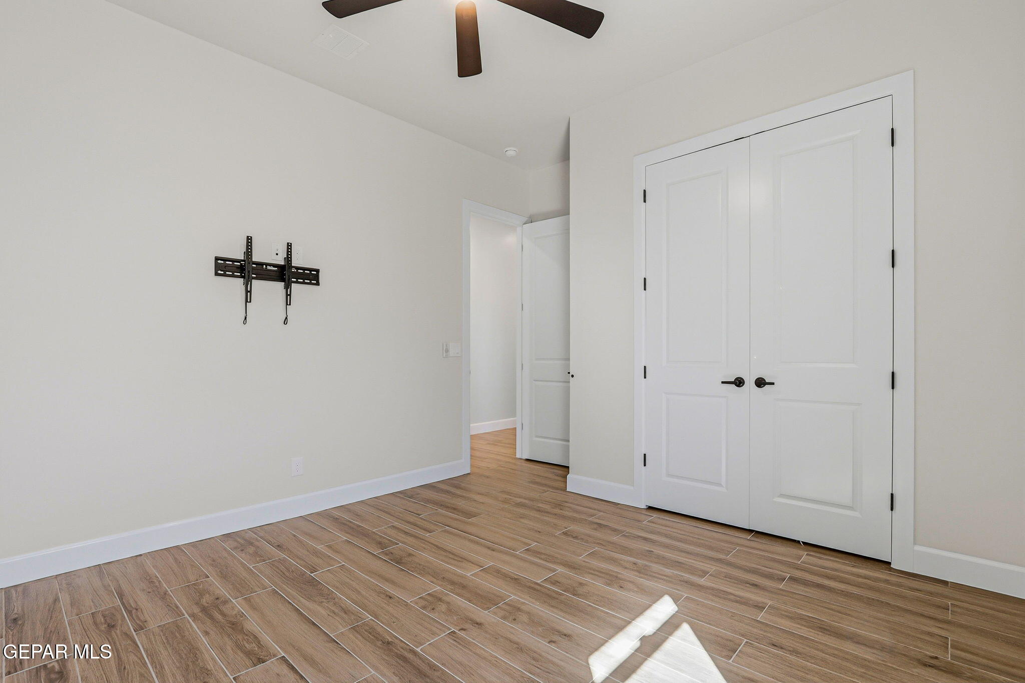 12329 Sugden Road Clint, TX 79836 - Photo 70 of 101 a view of a room with wooden floor and a ceiling fan
