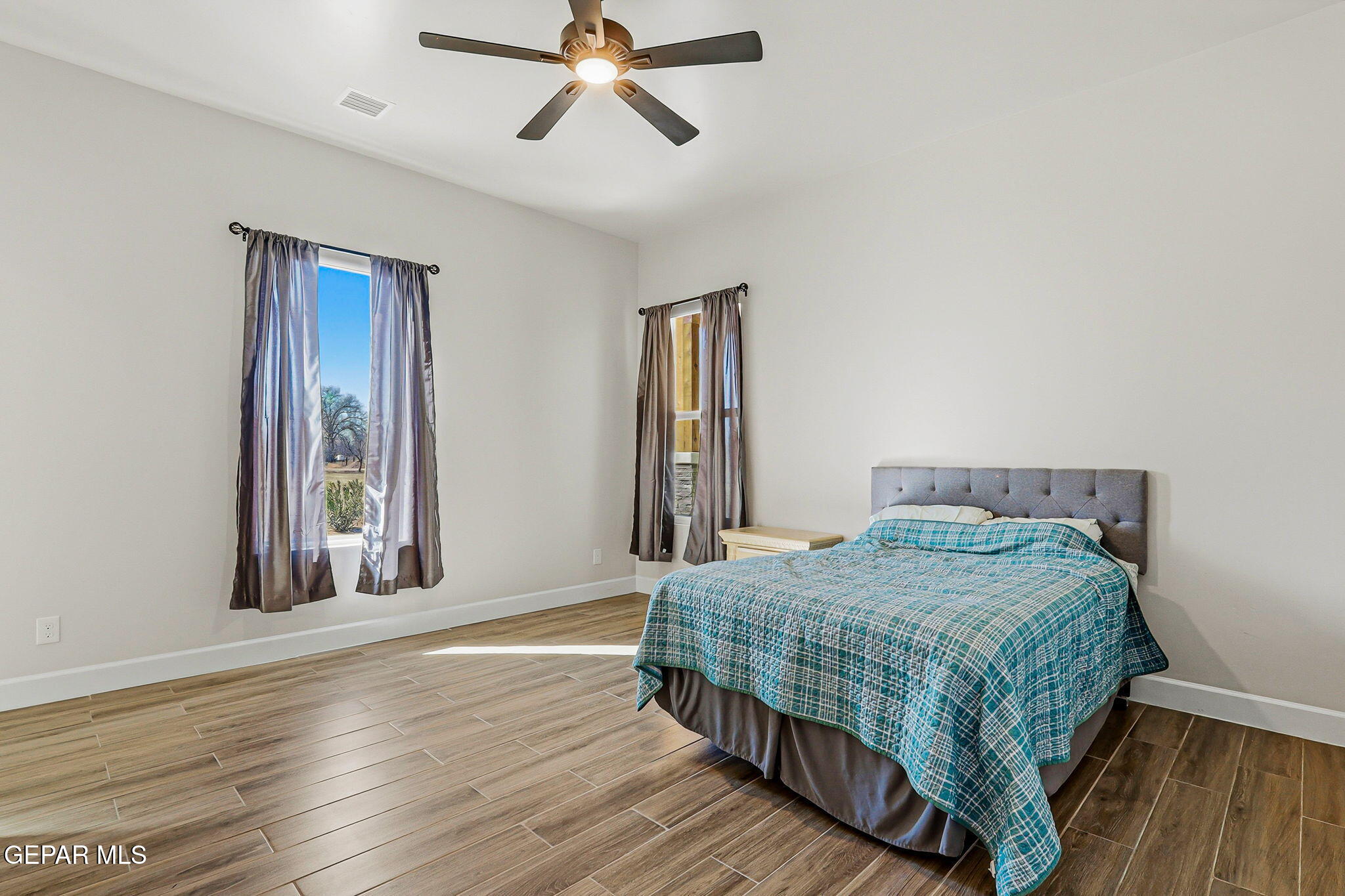 12329 Sugden Road Clint, TX 79836 - Photo 71 of 101 a bedroom with a bed and wooden floor
