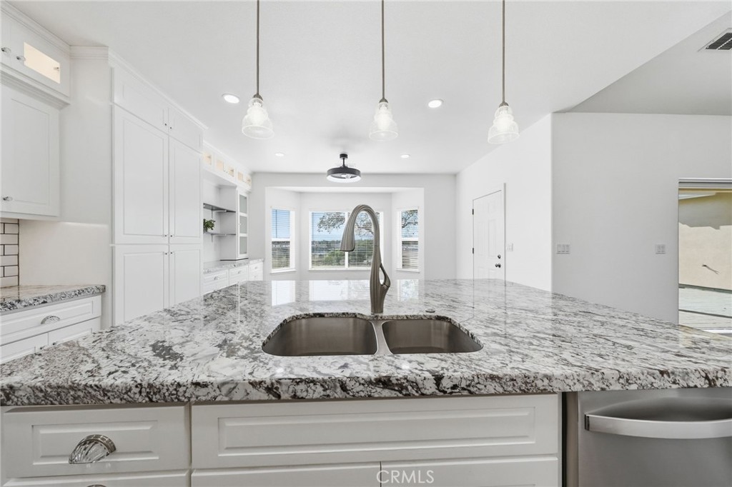 13925 Noble Way Red Bluff, CA 96080 - Photo 14 of 57 a kitchen with stainless steel appliances granite countertop a sink a refrigerator and a stove
