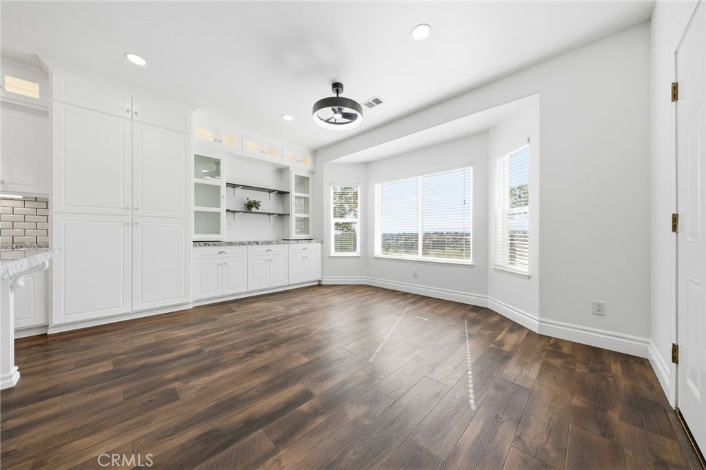 13925 Noble Way Red Bluff, CA 96080 - Photo 17 of 57 a view of an empty room with a window and wooden floor