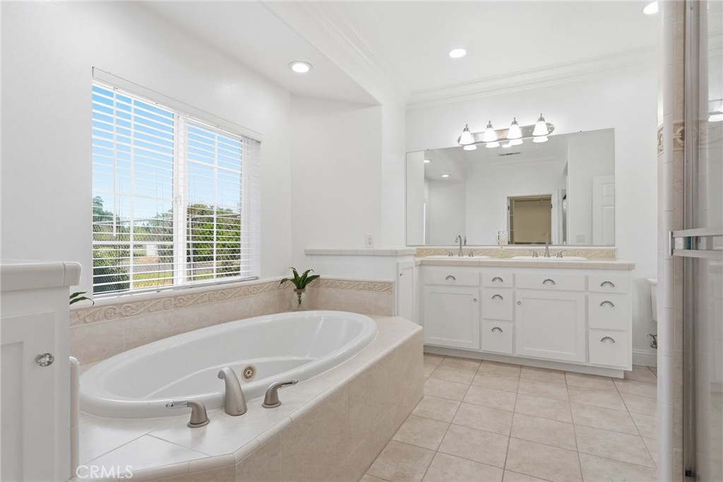 13925 Noble Way Red Bluff, CA 96080 - Photo 21 of 57 a spacious bathroom with a tub sink and mirror