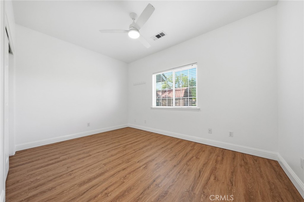 13925 Noble Way Red Bluff, CA 96080 - Photo 27 of 57 an empty room with wooden floor and windows