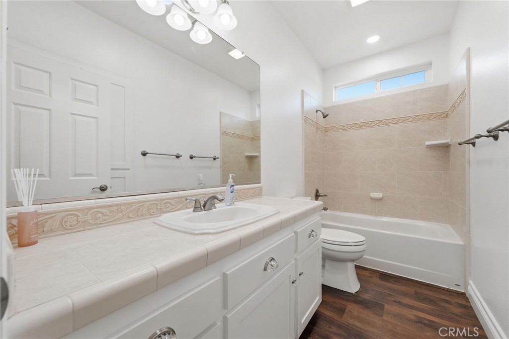 13925 Noble Way Red Bluff, CA 96080 - Photo 28 of 57 a bathroom with a granite countertop sink a toilet and a large mirror