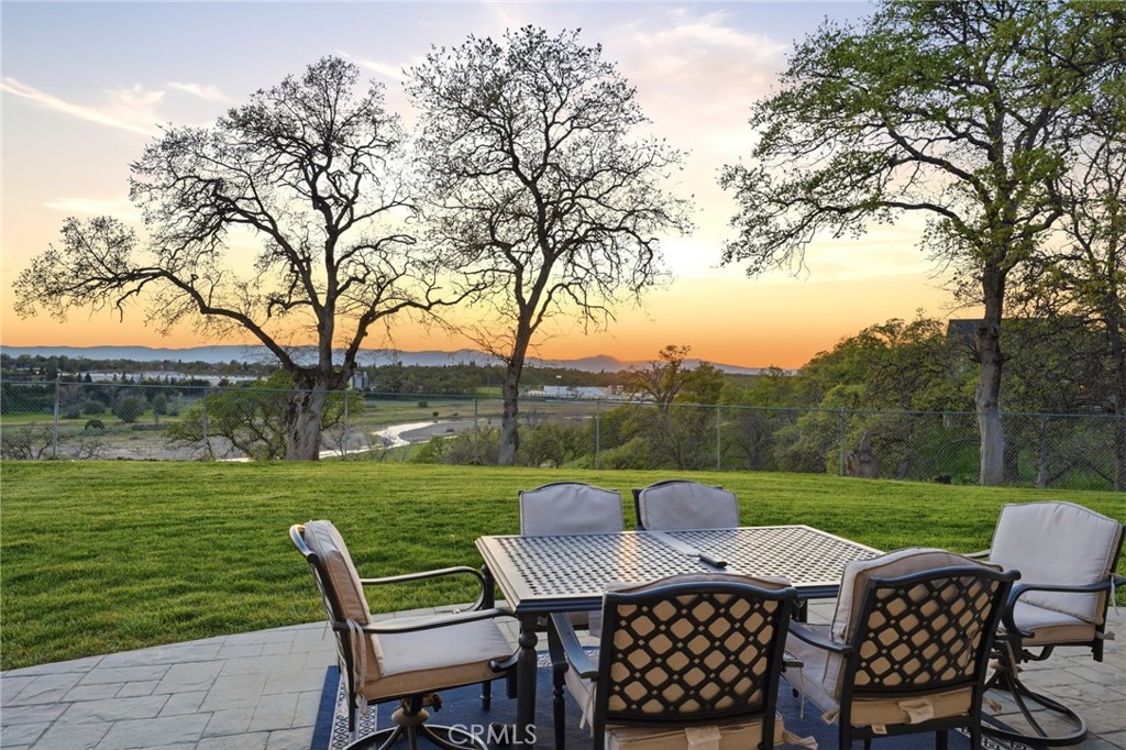 13925 Noble Way Red Bluff, CA 96080 - Photo 36 of 57 a view of a patio with a table chairs and a yard
