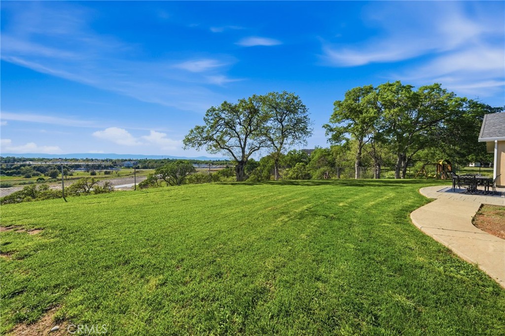 13925 Noble Way Red Bluff, CA 96080 - Photo 44 of 57 a view of a grassy field with an trees