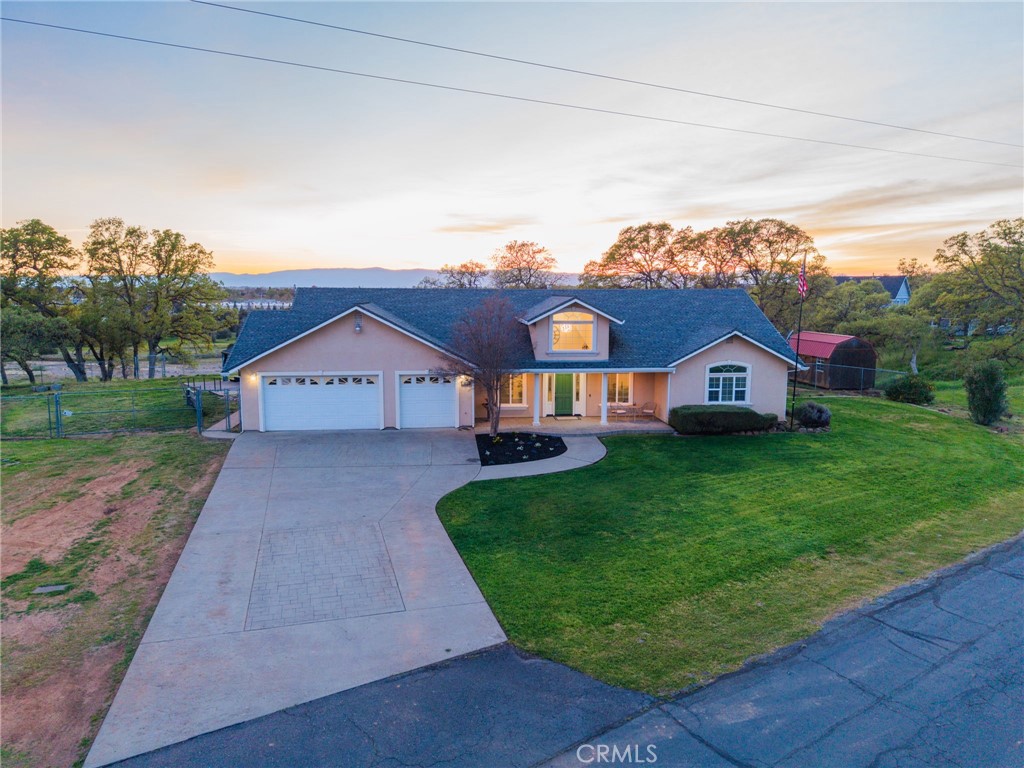 13925 Noble Way Red Bluff, CA 96080 - Photo 45 of 57 a house with green field in front of it
