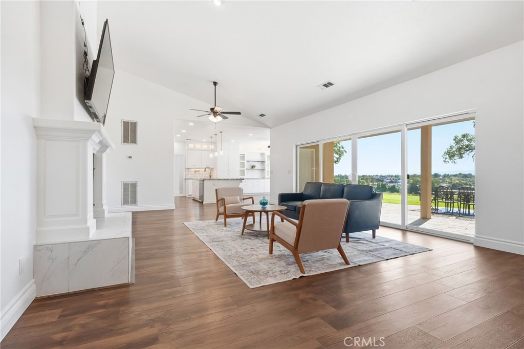 13925 Noble Way Red Bluff, CA 96080 - Photo 6 of 57 a living room with furniture a large window and wooden floor