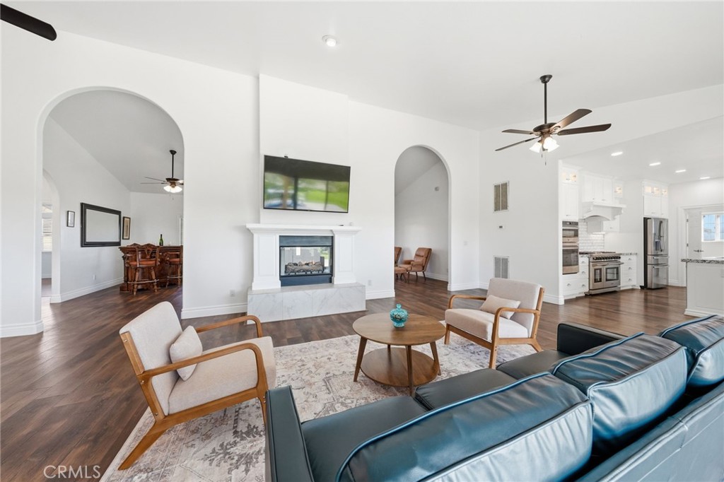 13925 Noble Way Red Bluff, CA 96080 - Photo 8 of 57 a living room with furniture a fireplace and a chandelier