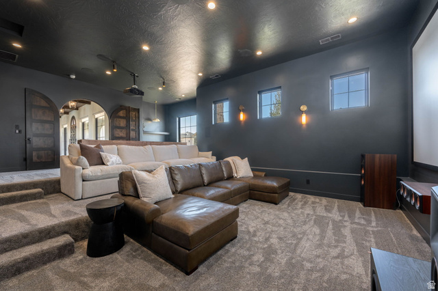 4871 South Homestead Way Washington, UT 84780 - Photo 54 of 151 Home theater featuring arched walkways, carpet floors, a textured ceiling, and track lighting