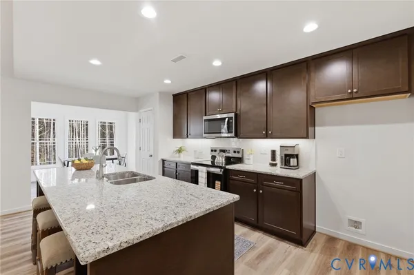a bathroom with a double vanity sink toilet and shower