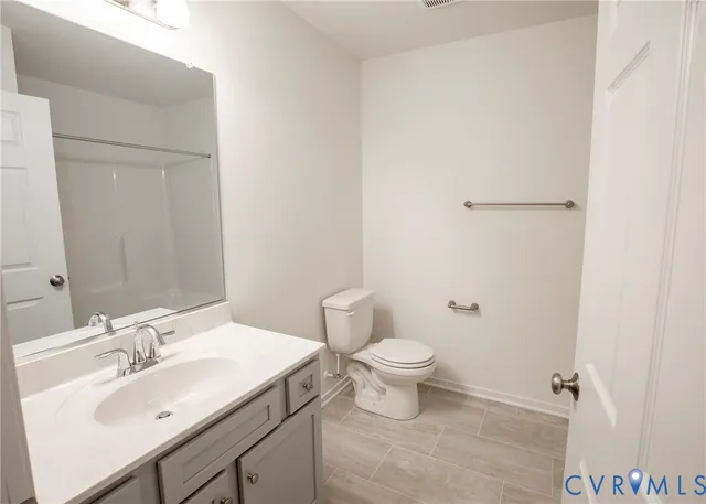 a bathroom with a sink toilet and vanity