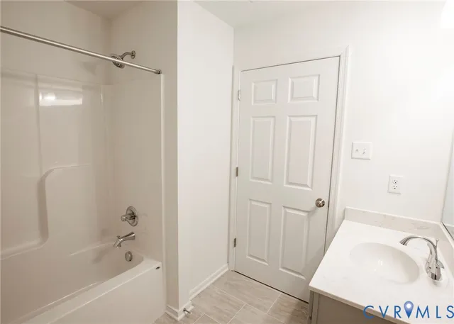 a bathroom with a tub and a sink