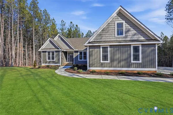 a front view of a house with a yard table and chairs
