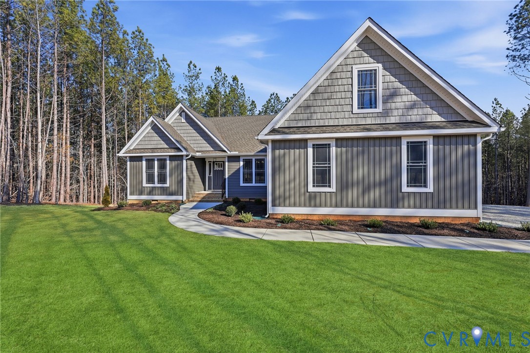 2214 Walnut Tree Boulevard Powhatan, VA 23139 - Photo 2 of 30 a front view of a house with a yard table and chairs