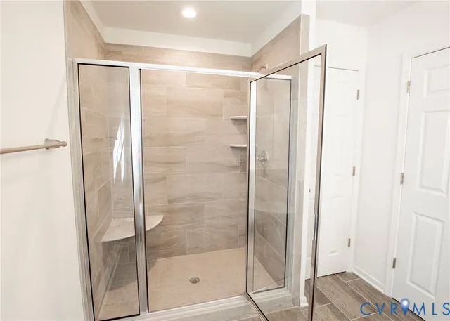 a bathroom with a glass shower door