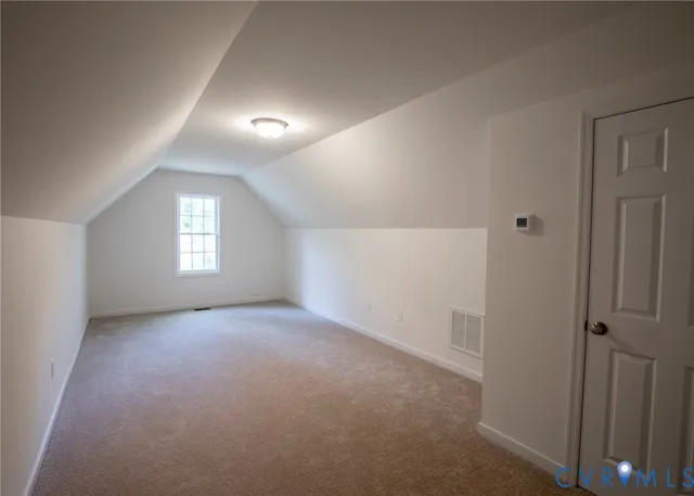 an empty room with windows and closet in a room