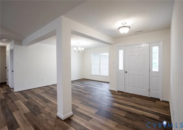 a view of a room with wooden floor