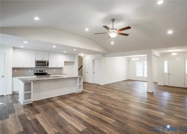 a view of kitchen with sink microwave and refrigerator