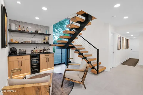 a view of staircase with furniture and window