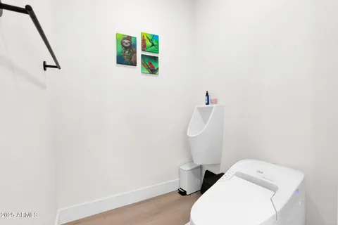 a bedroom with a bed and a potted plant on dresser