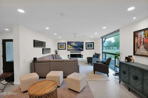 a living room with furniture a projector and a flat screen tv