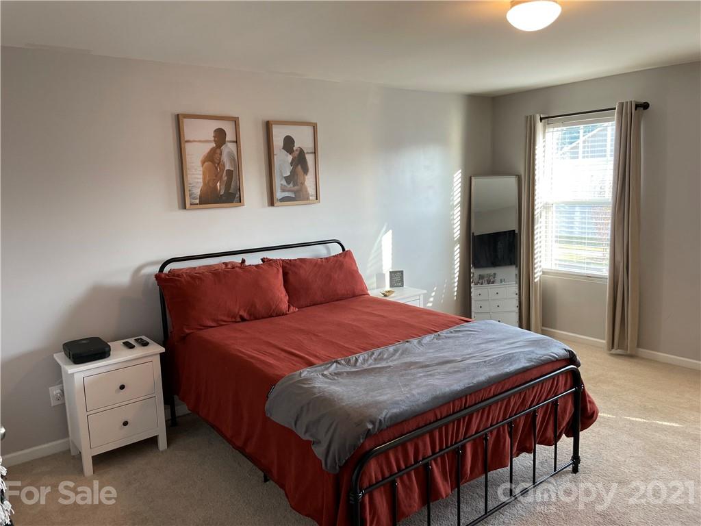 13026 Hill Pine Road, Unit 6 Midland, NC 28107 - Photo 28 of 37 a bedroom with a bed and wooden floor