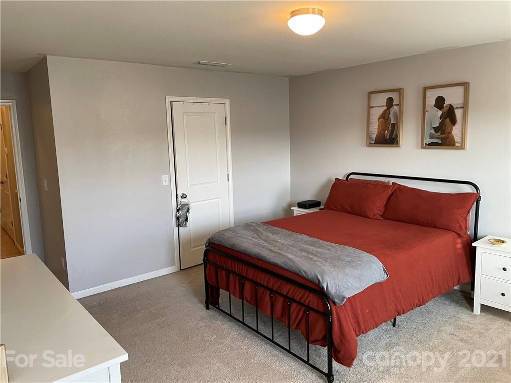 13026 Hill Pine Road, Unit 6 Midland, NC 28107 - Photo 29 of 37 a bedroom with a bed and painting on the wall
