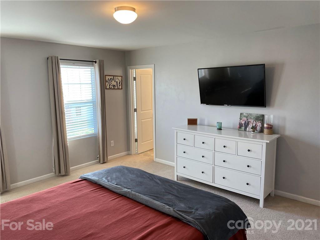 13026 Hill Pine Road, Unit 6 Midland, NC 28107 - Photo 30 of 37 a bedroom with a bed and a flat screen tv