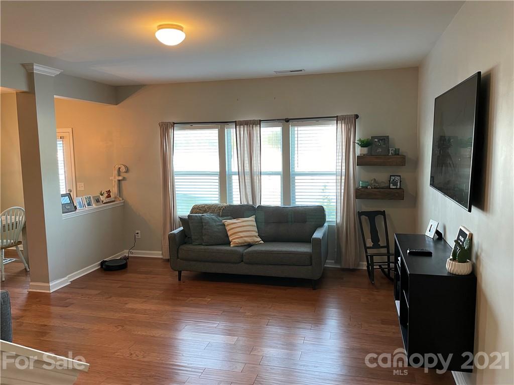 13026 Hill Pine Road, Unit 6 Midland, NC 28107 - Photo 5 of 37 a living room with furniture wooden floor and a flat screen tv