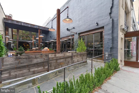a view of a brick building with a bench in front of building