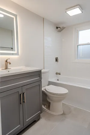 a bathroom with a toilet a sink and bathtub