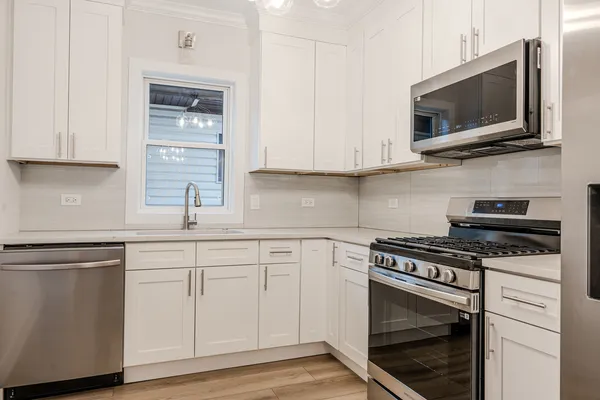 a kitchen with cabinets stainless steel appliances and a sink