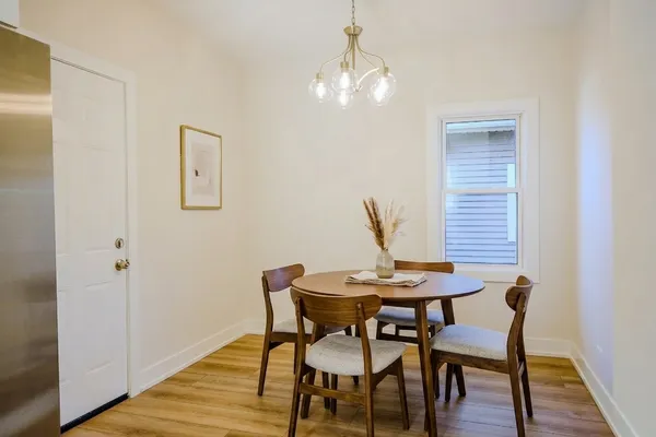 a view of a dining room with furniture and wooden floor
