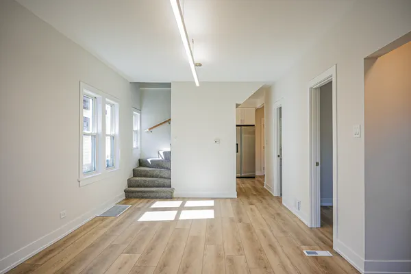 a view of a room with wooden floor and window
