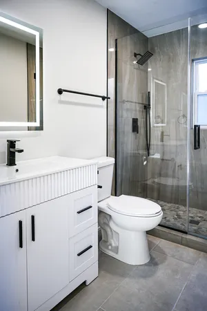 a bathroom with a toilet a sink and shower