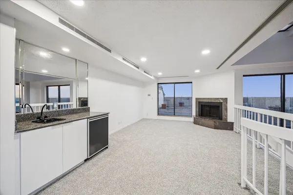 a kitchen with stainless steel appliances granite countertop a sink and stove top oven with wooden floor