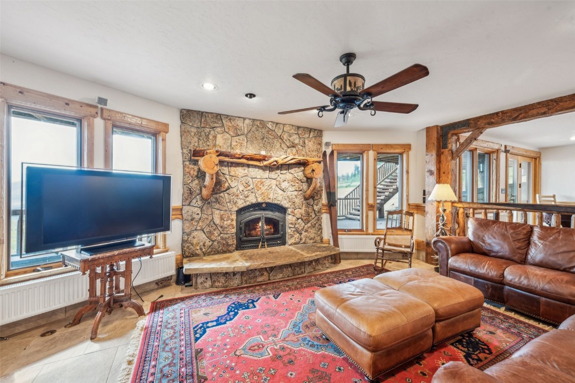 733 Spring Creek Ranch Road Silverthorne, CO 80498 - Photo 14 of 37 a living room with furniture a flat screen tv and a fireplace