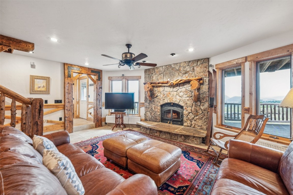 733 Spring Creek Ranch Road Silverthorne, CO 80498 - Photo 17 of 37 a living room with furniture a large window and a fireplace
