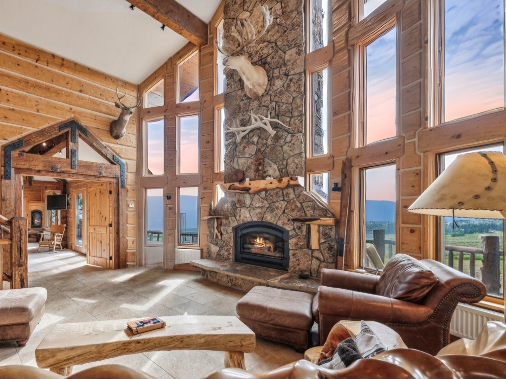 733 Spring Creek Ranch Road Silverthorne, CO 80498 - Photo 2 of 37 a living room with furniture a fireplace and a large window
