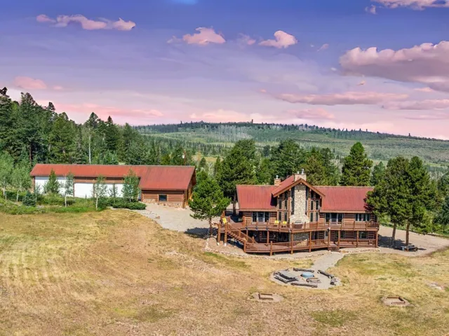 a view of swimming pool with a table and chairs under an umbrella