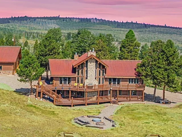 a view of a house with pool and a yard