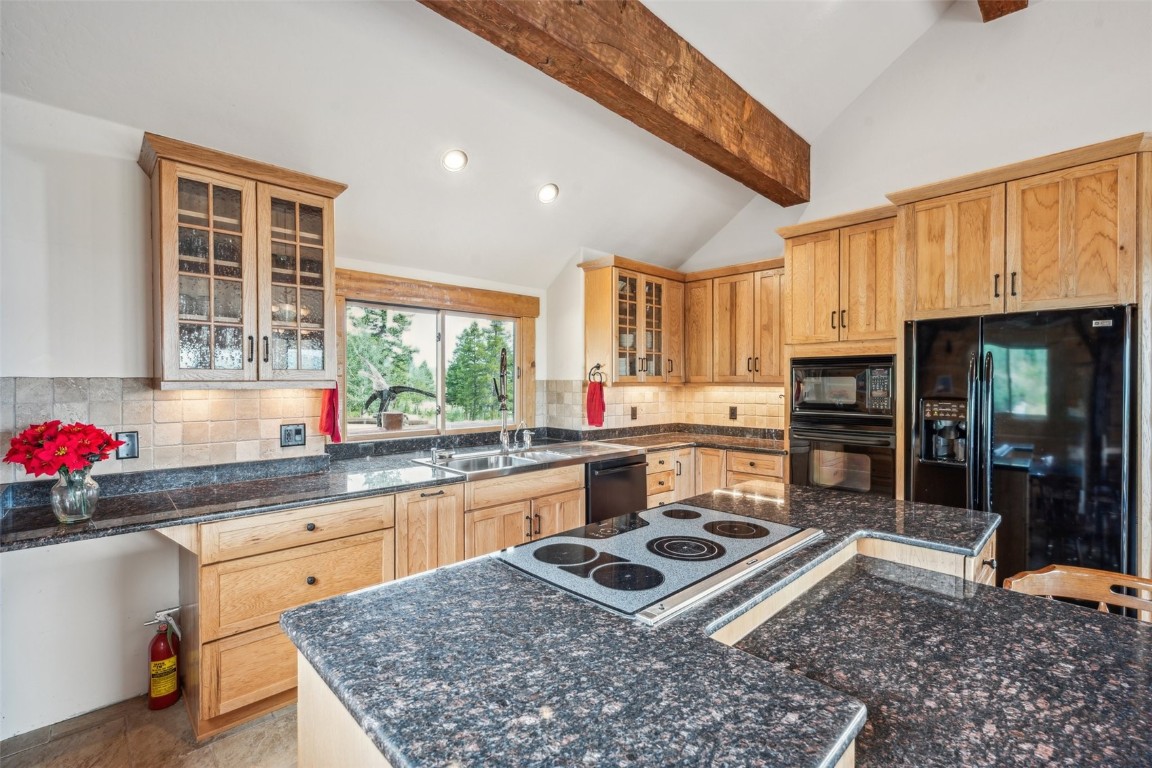 733 Spring Creek Ranch Road Silverthorne, CO 80498 - Photo 7 of 37 a kitchen with a stove a sink and a refrigerator